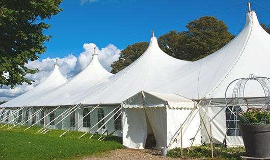 a group of luxury portable restrooms with individual stalls and running water in Flora